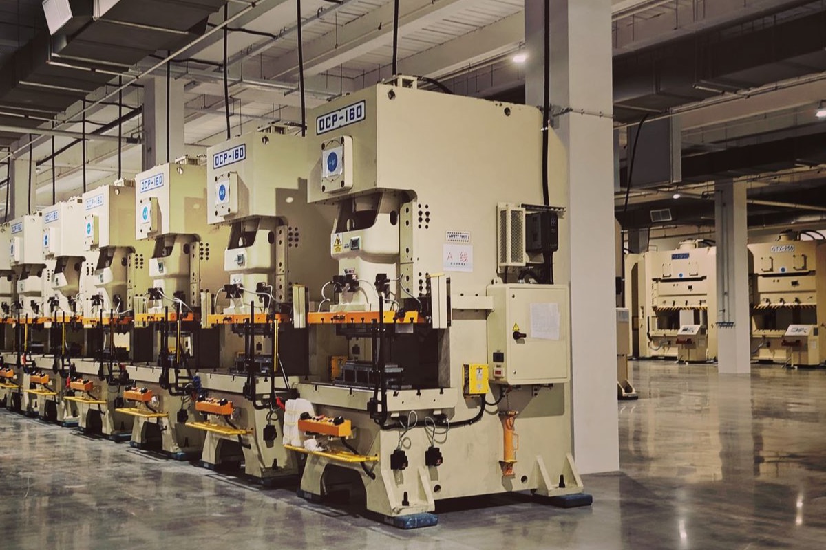 Row of press machines on a coated factory production floor